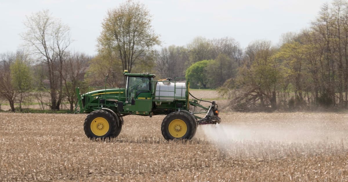 Tractor spraying crops on a farm